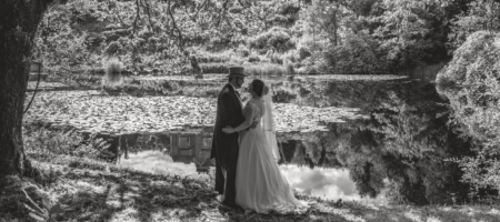 Bride and Groom standing beside the loch